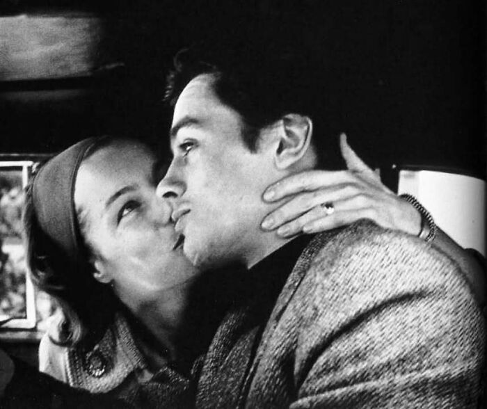 Black and white close-up of two people in an intimate moment, representing iconic figures in the movie and music industries.