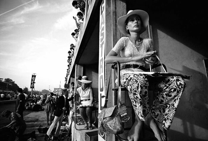 Woman in a wide-brimmed hat sitting at a film set, representing people who left a mark in movie and music industries.