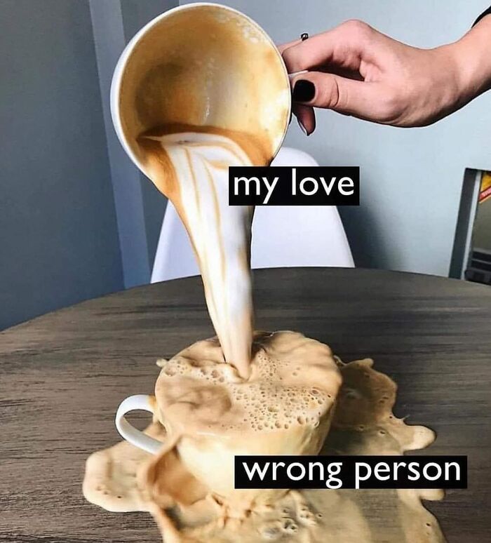 Overflowing coffee cup labeled my love pouring onto table labeled wrong person, illustrating relatable relationship memes.
