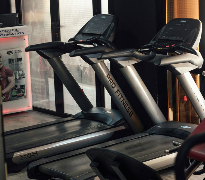 Two Pro Fitness treadmills in a gym setting highlighting amusing moments of people unaware of common knowledge.