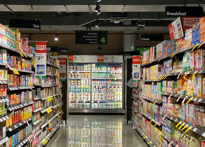 Supermarket aisle stocked with cereals, tea, and breakfast items, capturing wildest need to leave right now stories.