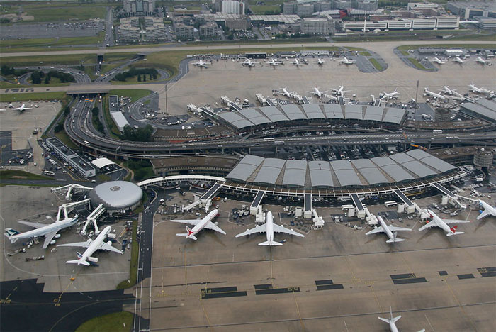 Aerial view of a busy airport terminal with multiple airplanes and taxiways, a place people wouldn’t revisit.