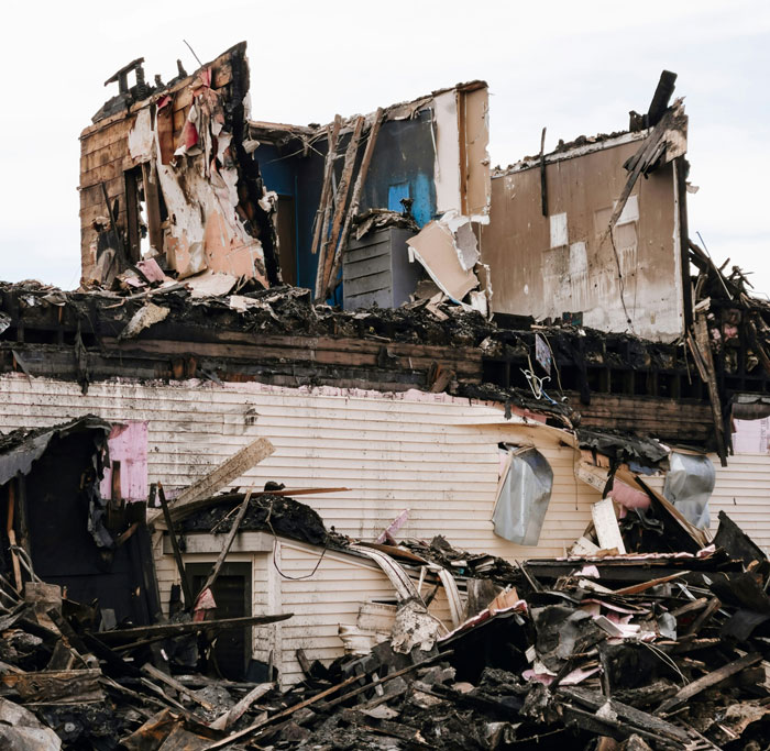 Partially destroyed house showing debris and wreckage, illustrating one-in-a-million coincidences in disaster scenes.