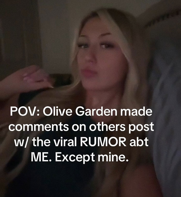 Young woman in a dim room reacting to viral Olive Garden hoax and student caught in insane rumor controversy. Young woman in a dim room reacting to viral Olive Garden hoax and student caught in insane rumor controversy.