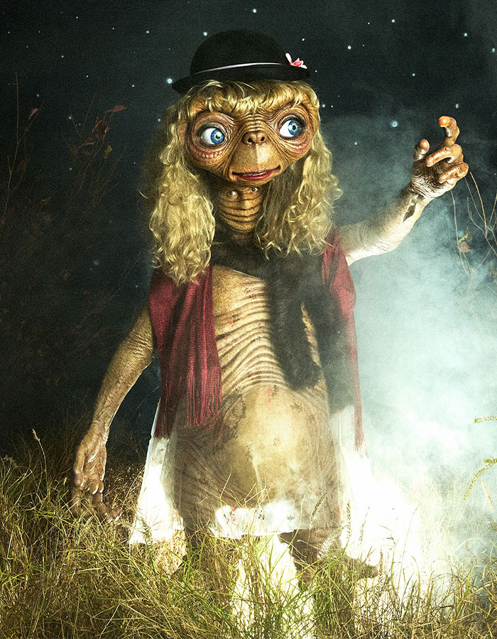 Alien creature with large blue eyes and blonde wig in a spooky setting, related to Heidi Klum nightmare-level 2025 costume.