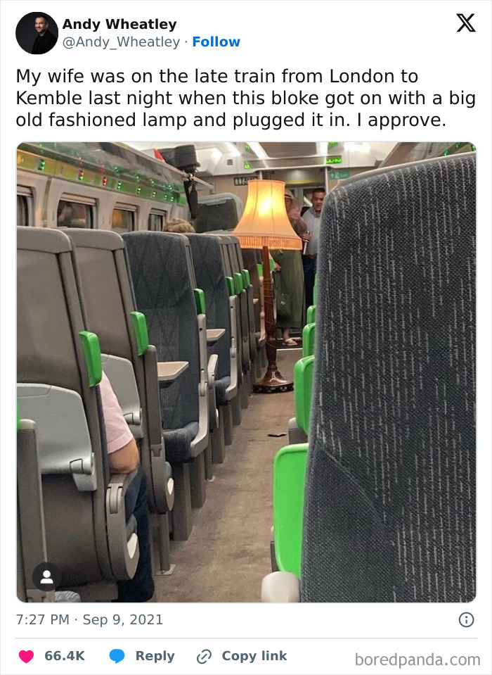 Inside a train carriage, a man plugs in a big old fashioned lamp creating a hilarious moment shared on tweets.