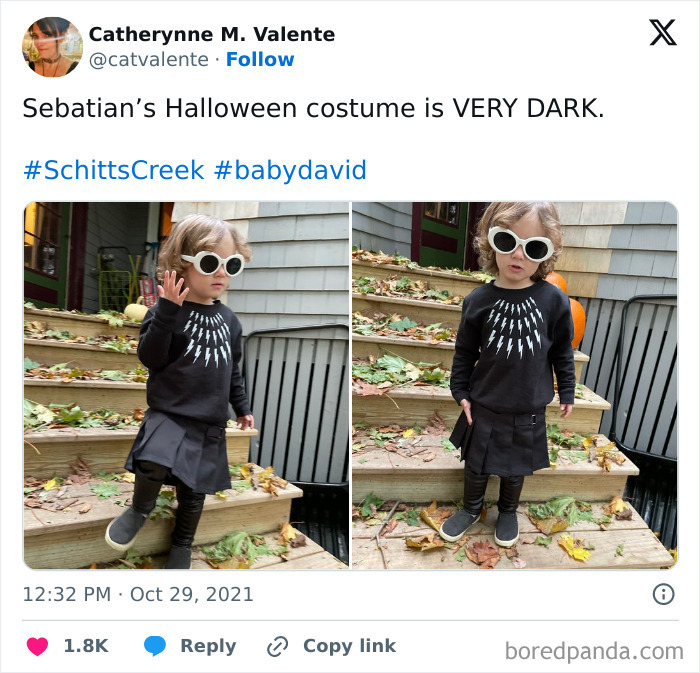 Toddler wearing a very dark Halloween costume with lightning bolt design and white sunglasses on outdoor steps.