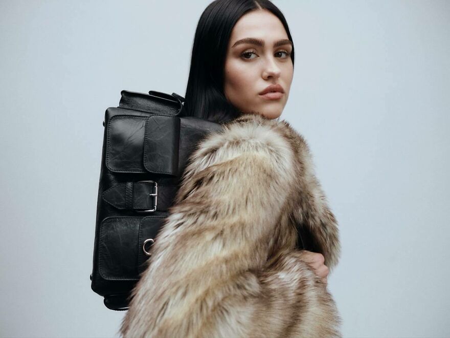 Amelia Gray in a fur coat carrying a black leather backpack, representing nepo babies defining Hollywood’s new generation.