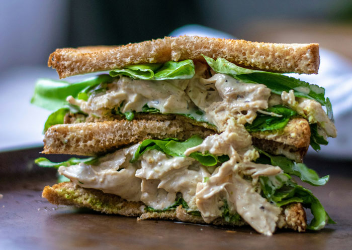 Close-up of a chicken sandwich with lettuce on toasted bread, highlighting the chicken sandwich main SEO keyword.