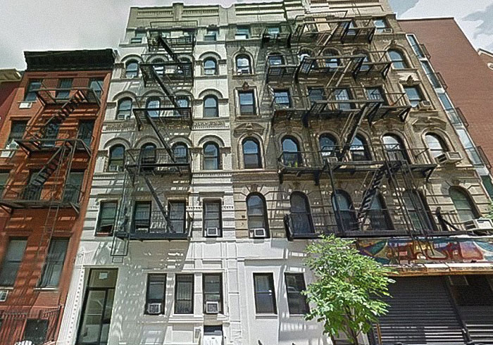 Old apartment building with fire escapes, related to David Harbour's viral interaction with a woman half his age.