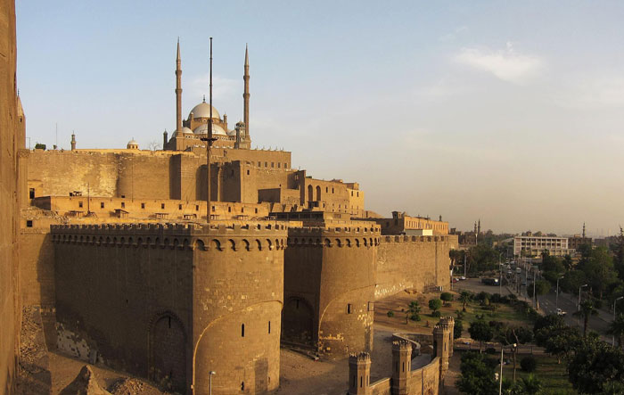 Historic fortress with mosque towers in the background, one of the places people wouldn’t revisit even if paid.