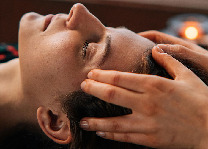 Close-up of a woman receiving a facial massage highlighting concerns after a cosmetic procedure realization.