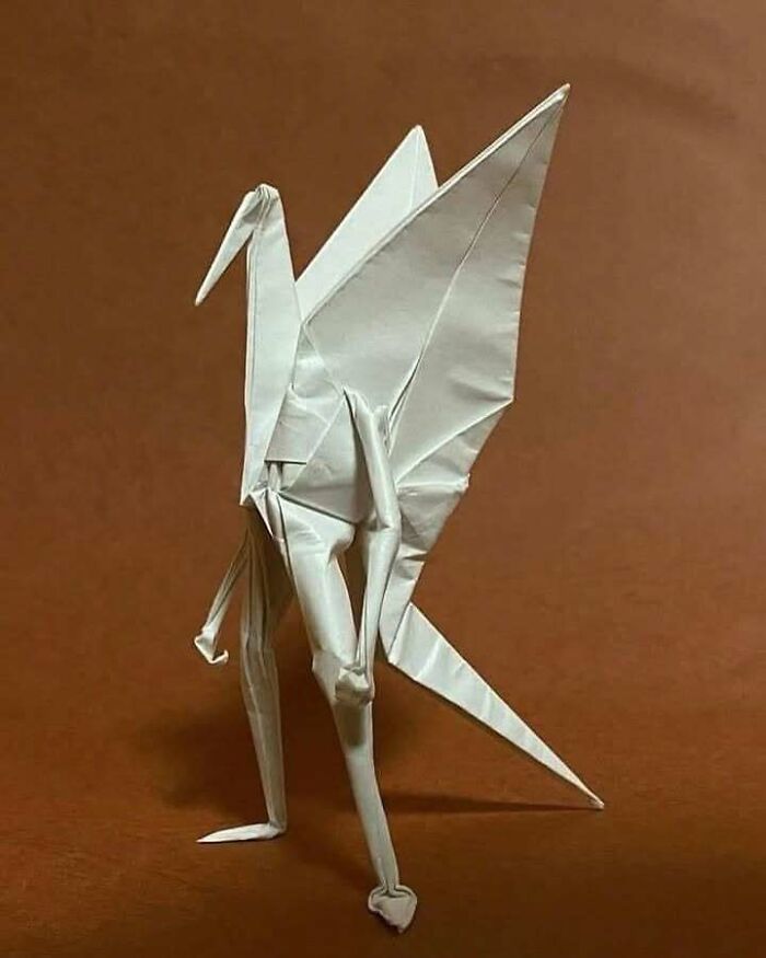 Origami figure with human-like legs and bird wings, a confusing image where things only get weirder the longer you look.