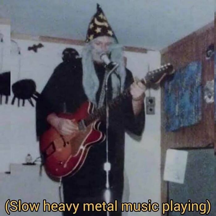 Person dressed as a wizard playing electric guitar with heavy metal music caption in a confusing image.