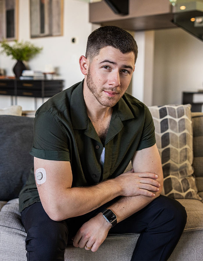 Young man with a short-sleeve shirt and smartwatch, highlighting famous men who are much shorter than fans imagined.