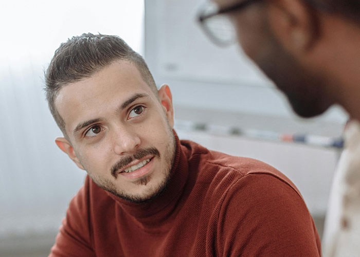 Two men having a thoughtful conversation, illustrating psychologists debunking mental health myths in a casual setting.