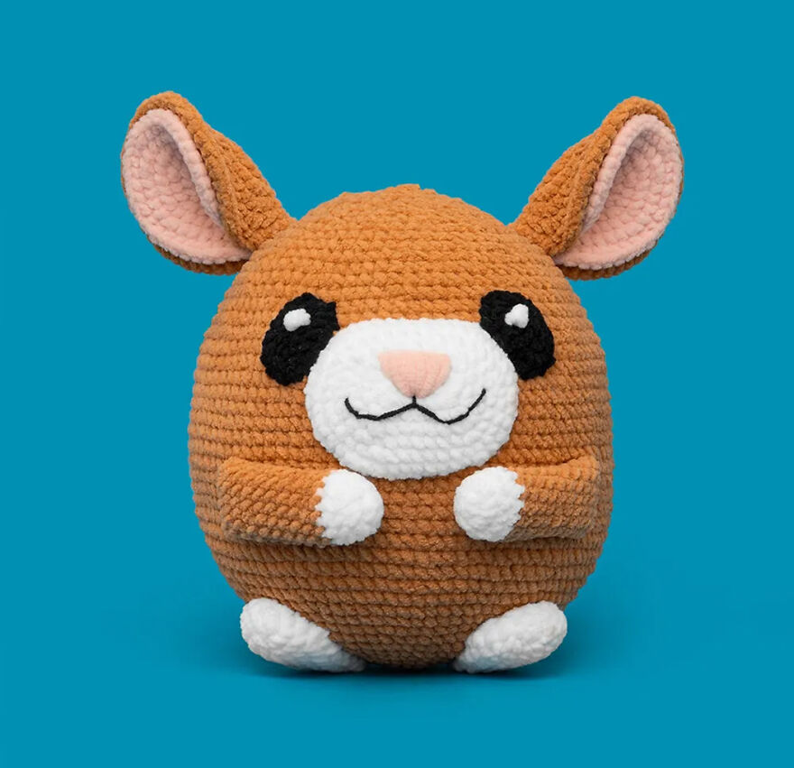 Crochet animal with expressive face and large ears made from soft yarn, showcasing unique personality and charm.