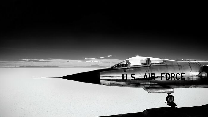 Black and white photo of a U.S. Air Force jet nose against a vast sky, featured in award-winning photography contest.