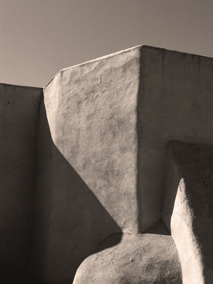 Minimalist architectural photo showcasing textured shadows and light contrast in an award-winning photography contest entry.