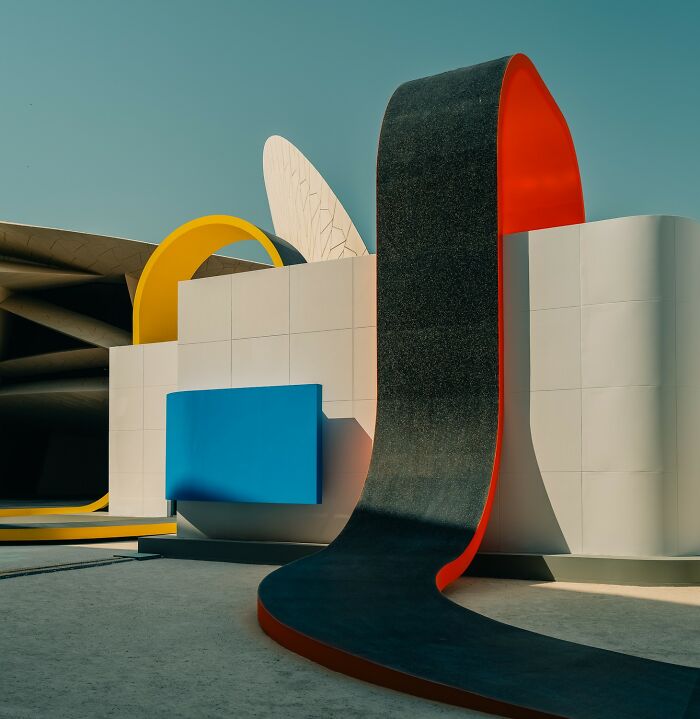 Abstract modern architectural installation featuring curved shapes and bold colors, highlighted in award-winning photography.