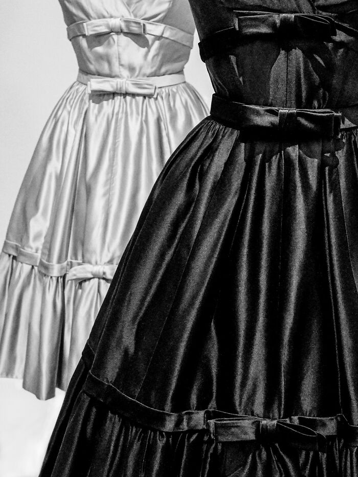 Black and white vintage style dresses with bows highlighting award-winning photos from the 2025 photographer of the year contest.