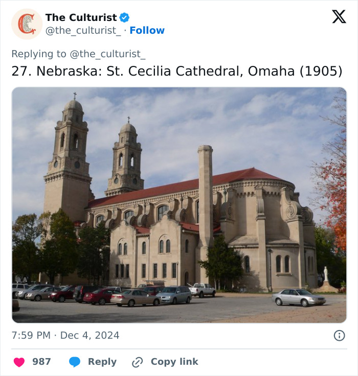 St. Cecilia Cathedral in Omaha, Nebraska, a beautiful and striking church with twin towers under a cloudy sky.