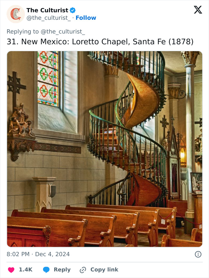 Spiral staircase inside Loretto Chapel, Santa Fe, showcasing striking church architecture and beautiful stained glass windows.