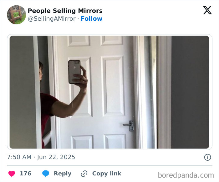 Person holding phone to take a mirror selfie showing reflection with white door in the background, mirror selling humor concept.