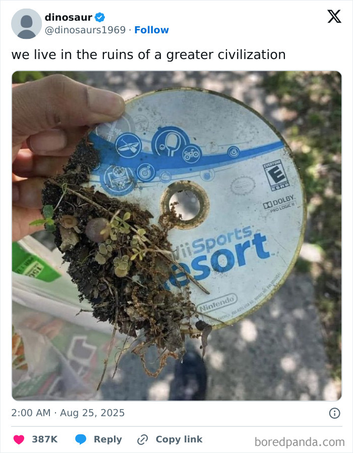 Hand holding a dirty, broken Wii Sports Resort game disc with plants growing on it, shared in hilarious tweets.