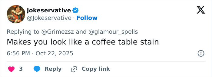 Tweet screenshot from user Jokeservative replying to Grimes with a comment comparing her face tattoo to a coffee table stain.