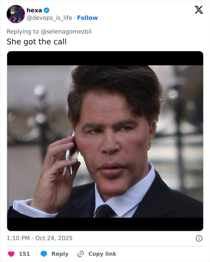 Man in a suit holding phone to his ear, expression intense, evoking reactions about Selena Gomez's face in new music video. Man in a suit holding phone to his ear, expression intense, evoking reactions about Selena Gomez's face in new music video.