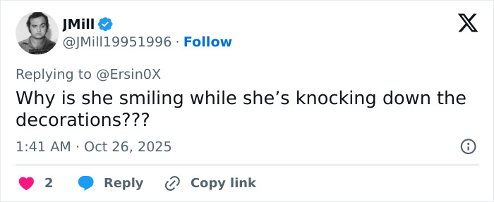 Tweet from user JMill questioning why a woman is smiling while knocking down Halloween witch decorations.