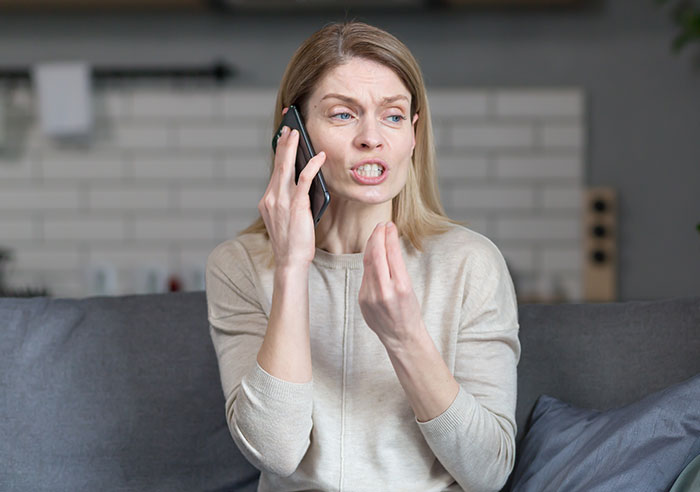 Woman talking on phone with a frustrated expression, reacting to a heartbreaking truth from daughter's boyfriend's mom. Woman talking on phone with a frustrated expression, reacting to a heartbreaking truth from daughter's boyfriend's mom.