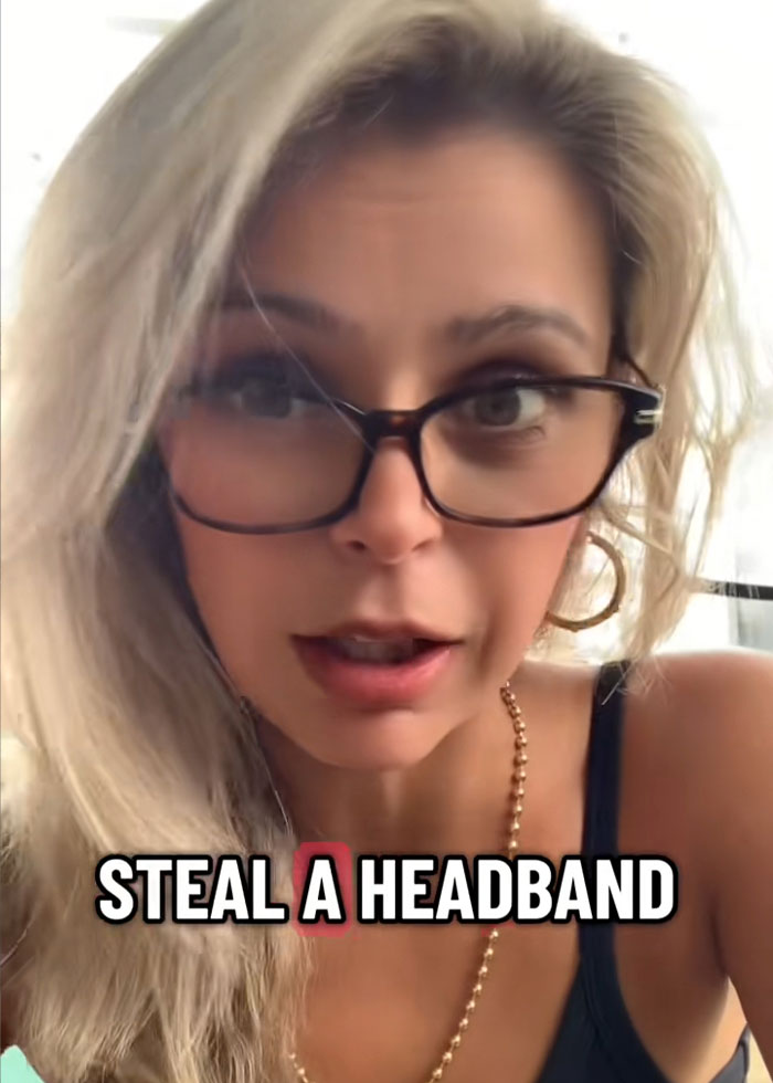 Woman with glasses speaking in a video about the viral Kansas City Karen who snatched headband from 10-year-old boy.