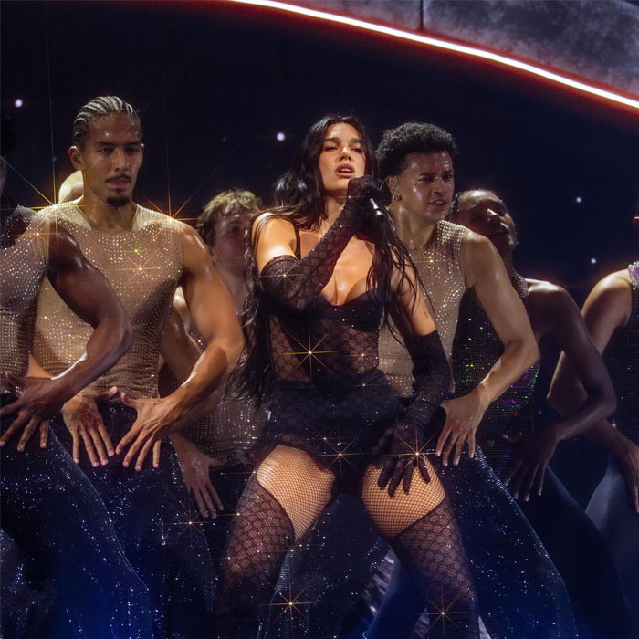 Dua Lipa performing on stage with backup dancers amid massive outrage over inappropriate touching incident at concert. Dua Lipa performing on stage with backup dancers amid massive outrage over inappropriate touching incident at concert.