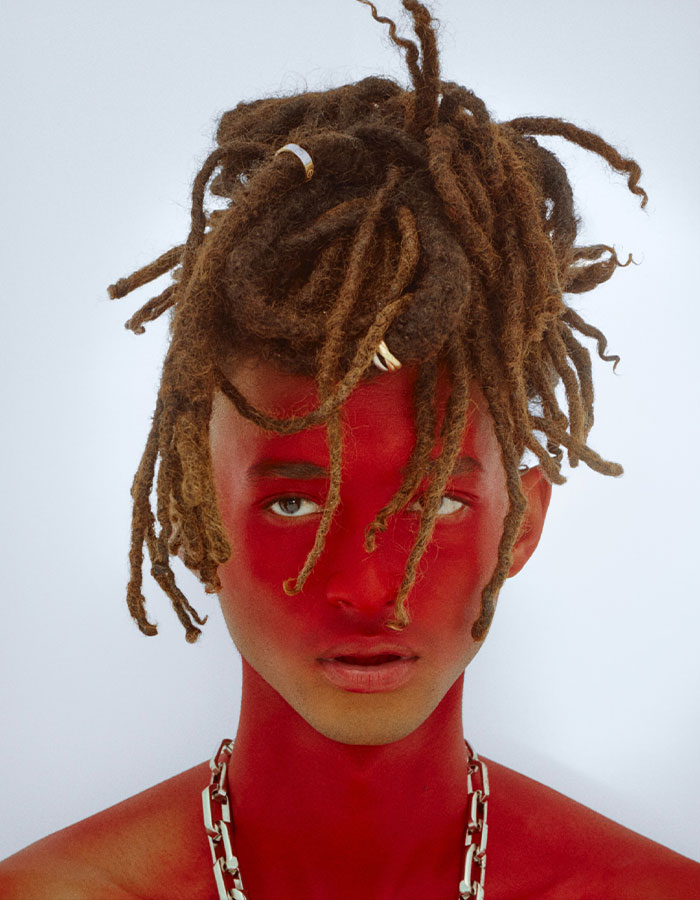 Jaden Smith with red face paint and dreadlocks wearing a chain necklace in a bold Paris fashion look. Jaden Smith with red face paint and dreadlocks wearing a chain necklace in a bold Paris fashion look.