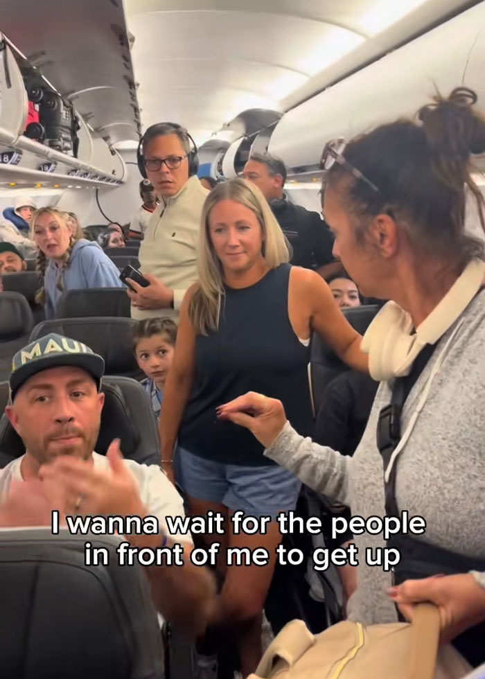 Passengers on a plane visibly upset as a confrontation involving a Karen unfolds, capturing tense moment during flight dispute. Passengers on a plane visibly upset as a confrontation involving a Karen unfolds, capturing tense moment during flight dispute.