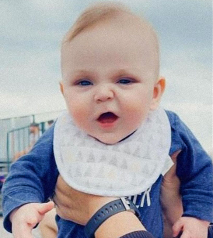 6-month-old baby being held outdoors, related to pit bull attack and father's guilty plea in the incident.