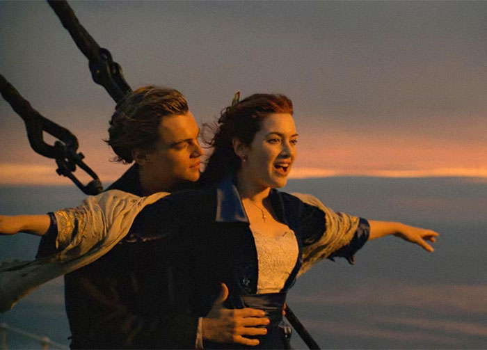Couple reenacting iconic Titanic pose at sunset, while daycare workers share unexpected family secrets experiences.