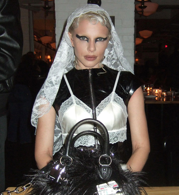 Julia Fox wearing a barely-there dress with lace veil and dramatic makeup at a gala sparking backlash online.