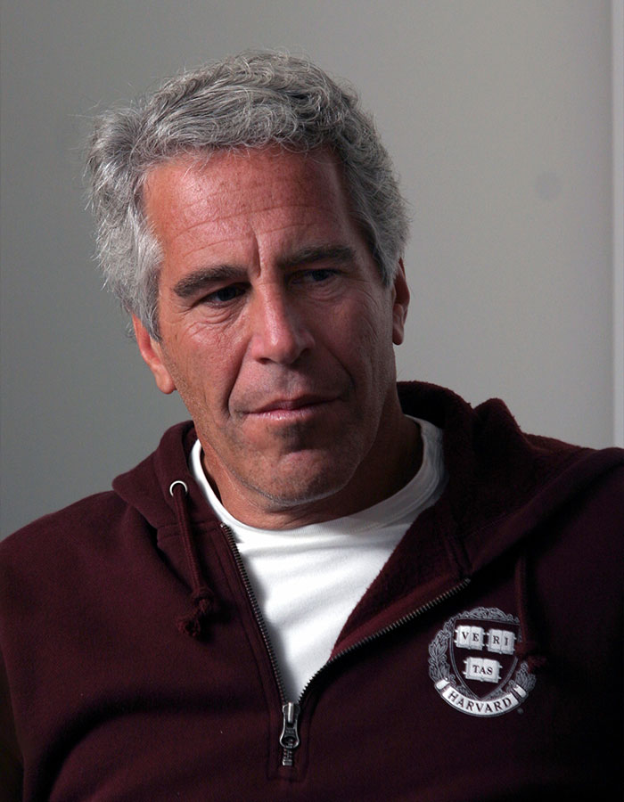 Man with gray hair, wearing a maroon Harvard hoodie, reflecting on new Prince Andrew allegations in Virginia Giuffre's memoir.