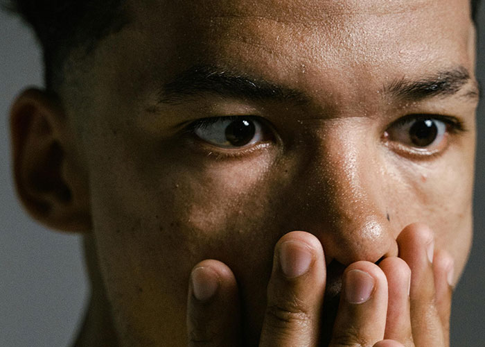 Close-up of a man with a worried expression, highlighting creepy things women said or did that left men horrified.