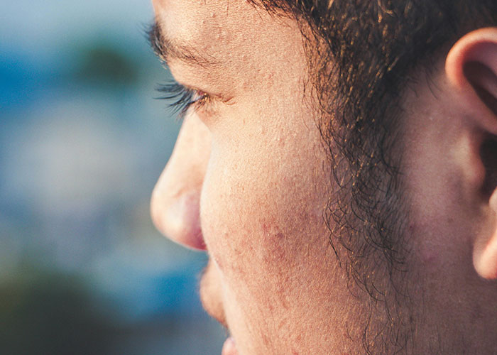Close-up side profile of a person deep in thought, illustrating moments of using loopholes against horrible bosses.