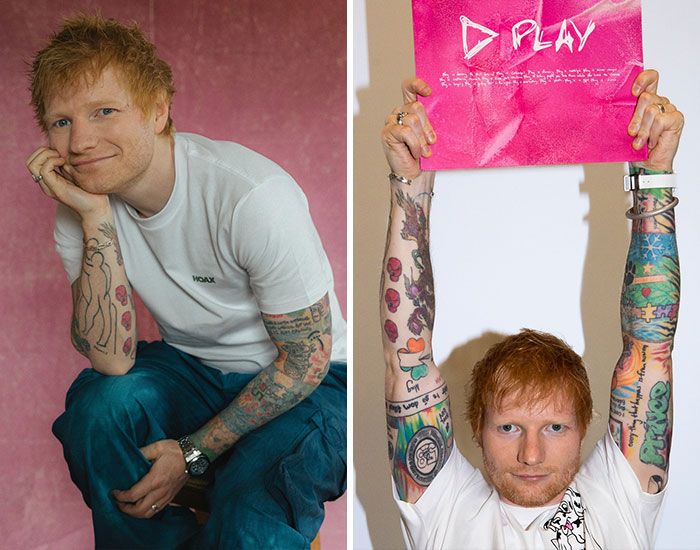 Ed Sheeran showing off colorful tattoos on both arms wearing casual clothes in a relaxed and playful setting.