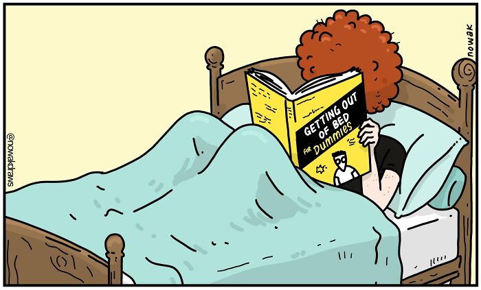 Person with curly red hair in bed reading a humorous one-panel comic book titled Getting Out of Bed for Dummies.