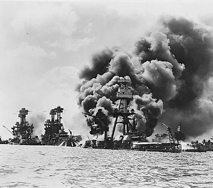 World War II battleships engulfed in thick smoke during a naval attack, illustrating shocking moments from history.