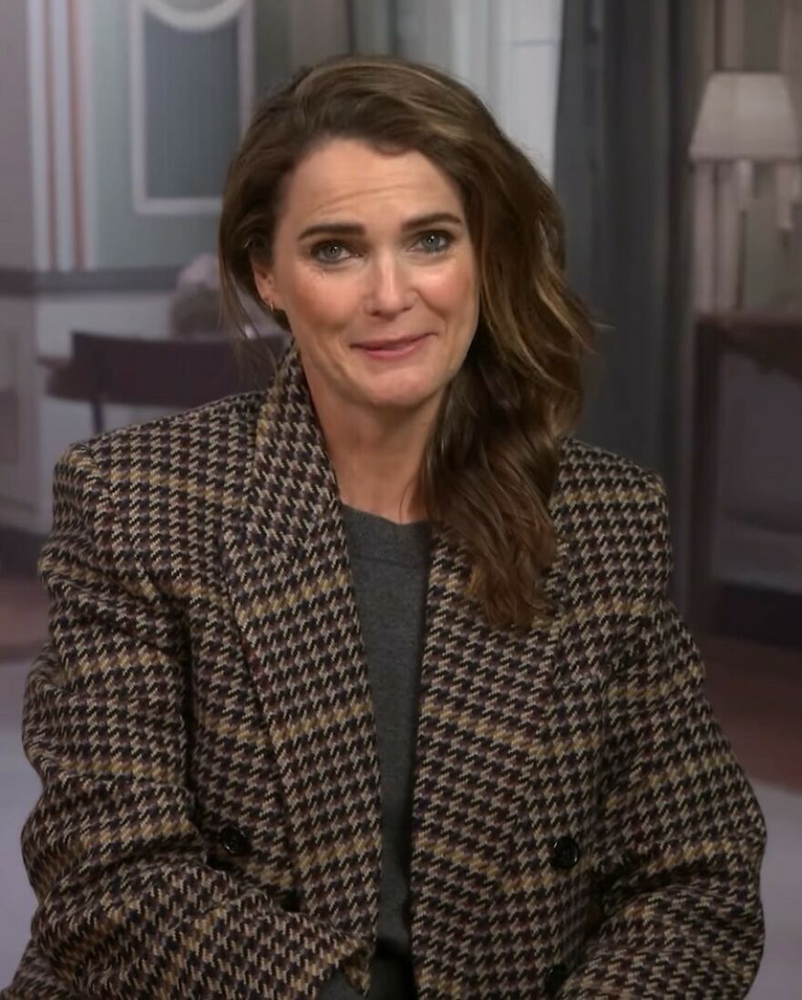 Keri Russell speaking against Hollywood's growing plastic surgery trend, wearing a patterned coat in an indoor setting.