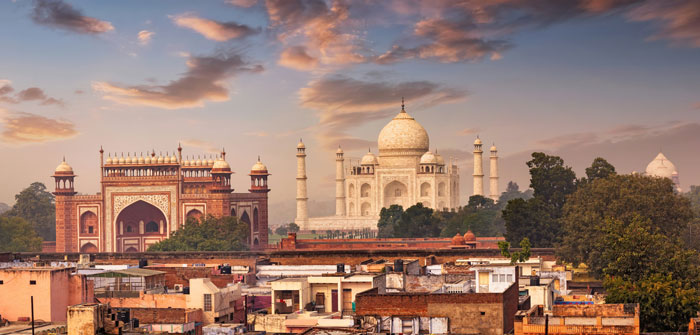 Taj Mahal at sunset over crowded rooftops, evoking worst places travel anecdotes