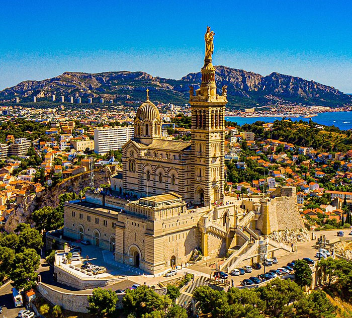 Aerial view of seaside basilica and cityscape used to illustrate worst places travelers mention