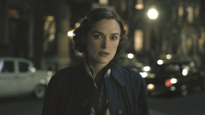 Actress portraying a character in a movie based on true stories, set in a nighttime urban scene.